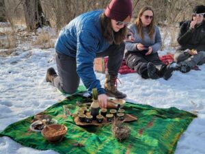 Brandy pouring tea in snow - Association of Nature & Forest Therapy